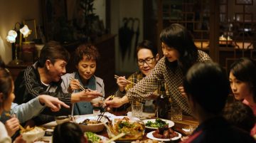 ALL SHALL BE WELL5 Family Dinner Angie Stands ©2023 Mise En Scene Filmproduction